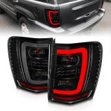 ANZO 1999-2004 Jeep Grand Cherokee LED Tail Lights w/ Light Bar Black Housing Smoke Lens thumbnail 1